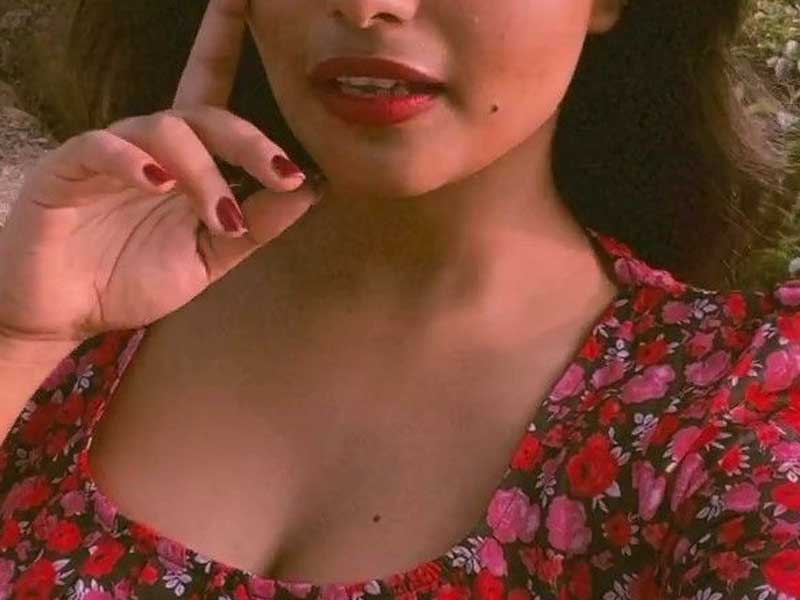 beautiful girl in red lips, red nails, and red floral outfit