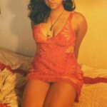 beautiful call girl ready for some action in bed, looking sensual in pretty short pink nightie