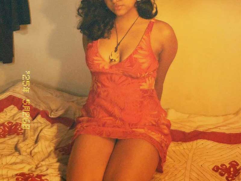 beautiful call girl ready for some action in bed, looking sensual in pretty short pink nightie